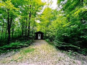 A forest path leading to a small cabin. - Romantic Cabin for a Cozy Escape in Nature near White Lake, Wisconsin (White Lake)
