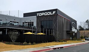 A building with the sign 'TOPGOLF' indicating a golf facility.