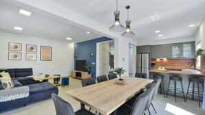 A modern apartment with a living room, dining area, and kitchen. - Villa Rea 3 with heated pool (Privlaka)