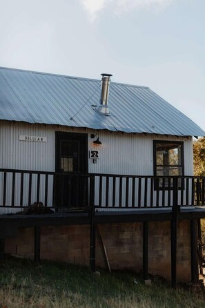A building with a corrugated metal roof, a black door, and a sign that reads 'DELIHAM.' - Off-Grid, Rustic, Two Bedroom Cabin Nestled in the Sequoias, Perfect for a Weekend to Disconnect in Nature (Dunlap)