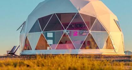 Luminous Cozy Dome with a Barbie Collection Above Bed in Willcox, Arizona