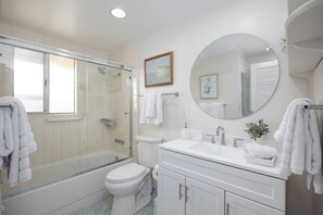 Jetted bath, hair dryer, towels, toilet paper
