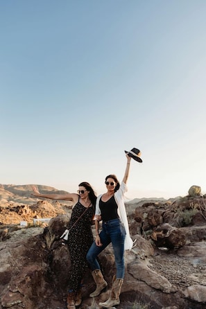 Two people standing on rocky terrain with a clear sky in the background. - Unique Dome with Great Desert Views in Terlingua, Texas (Terlingua)