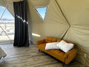 Una carpa con sofá y ventana.