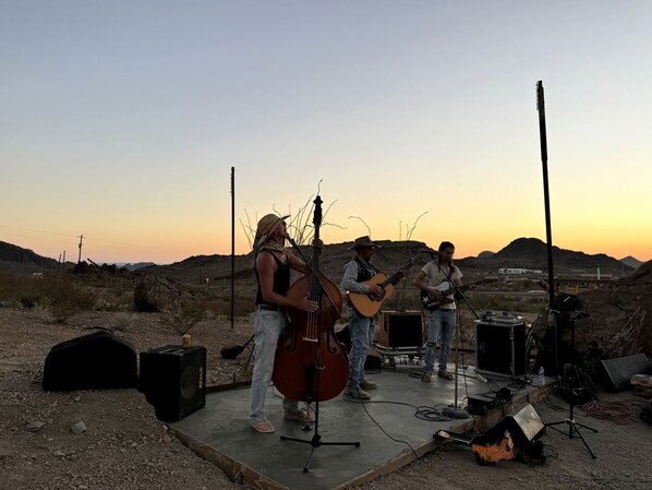 A band performing outdoors with musical instruments and equipment.