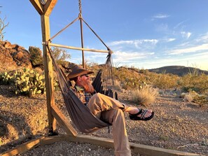 A man relaxing in a hammock outdoors. - Impressive Dome with Great Panoramic Desert Views in Terlingua, Texas (Terlingua)