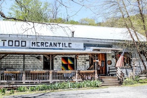 A rustic building with a sign reading 'TODD MERCANTILE' and a 'BAKERY' sign above the entrance.