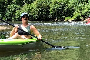 A person in a green kayak on a river. - Peaceful Cottage with Hot-tub in Todd, North Carolina (Fleetwood)