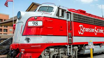 A red and white train with the number 98 and the name 'Branson Scenic' on its side.