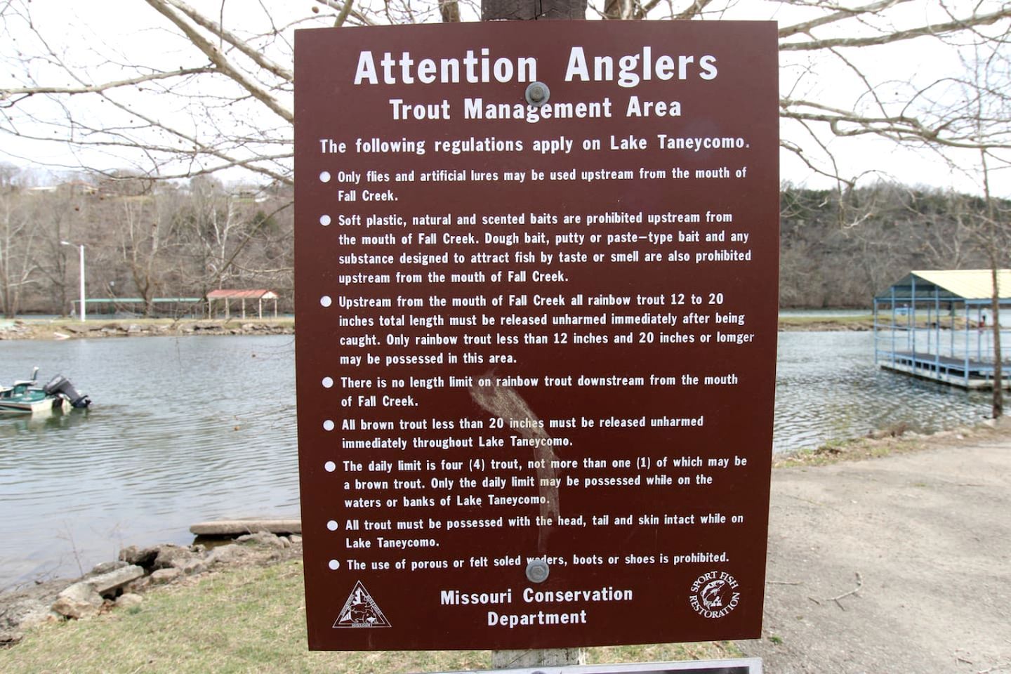 A sign detailing trout management regulations at Lake Taneycomo.