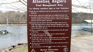 A sign detailing trout management regulations at Lake Taneycomo.