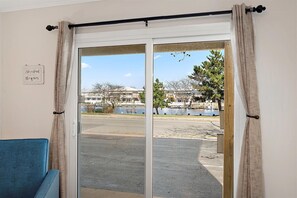 A room with a view of a waterfront, a bench, and a sign on the wall. - Three Bedroom Condo with Pool in North Ocean City (Ocean City)