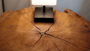 A table with a lamp on a wooden surface.