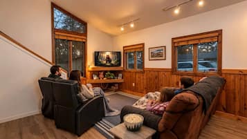 A cozy living room with a fireplace, a television, and a comfortable seating area.