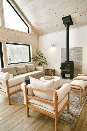 Fireplace - Riverside Retreat: Unwind in a Cabin with Private Steam Sauna on the Pine River (Mission Township)
