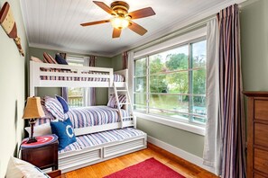 A bunk bed room with a ceiling fan, a window with curtains, and a red rug. - Lynchburg's Best-Kept Secret: A Unique Rental with Private Dock and Open Water Views (Lynchburg)