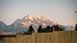 A mountain with a wooden fence in the foreground. - Gorgeous A-Frame Cabin for Two near Yellowstone with Incredible Glampground Amenities in Emigrant, Montana (Emigrant)