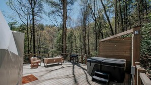 A wooden deck with a hot tub, wicker furniture, and a tent. - Unmatched Views Await You at this Cherry Log, Georgia Designer Dome near Fall Branch Falls (Cherry Log)