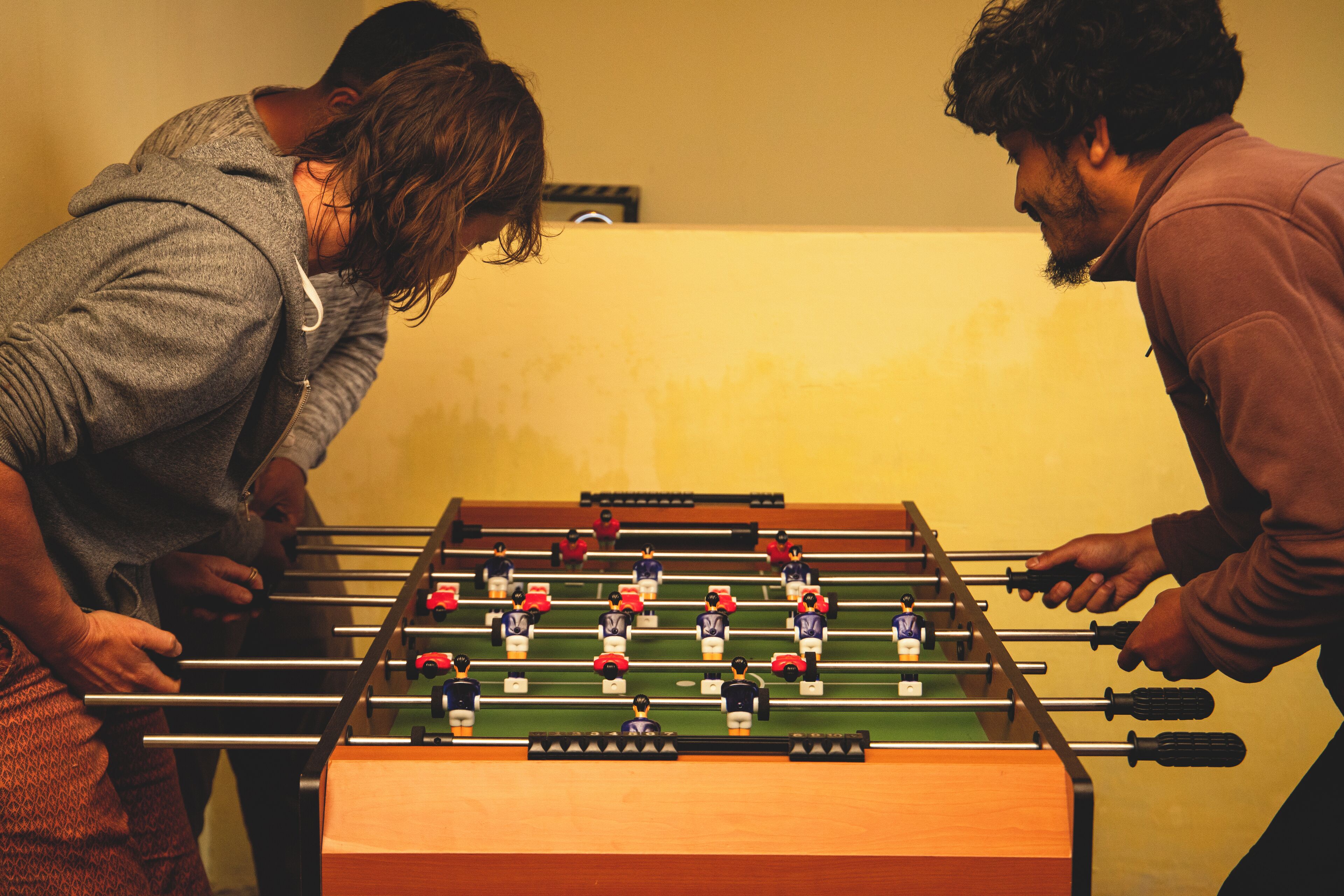 A foosball table with players in a casual indoor setting.