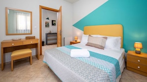 A bedroom with a bed, bedside tables, a desk, a chair, and a mirror. - Rodini Anassa | Apollo, Apartment (Rodos)