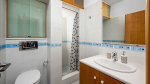 A bathroom with a toilet, shower, and sink. - Rodini Anassa | Dimitra, Apartment (Rodos)