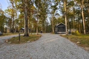 A campground with gravel paths, cabins, and a forested area. - Stunning Mountain Tiny House Beautifully Design Ideal for Nature Lovers in Tennessee (Monteagle)