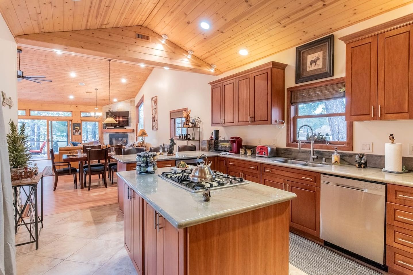 A spacious kitchen with wooden cabinets, a central island, and a view of the outdoors.