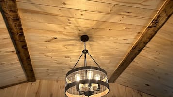 A wooden ceiling with a circular chandelier.