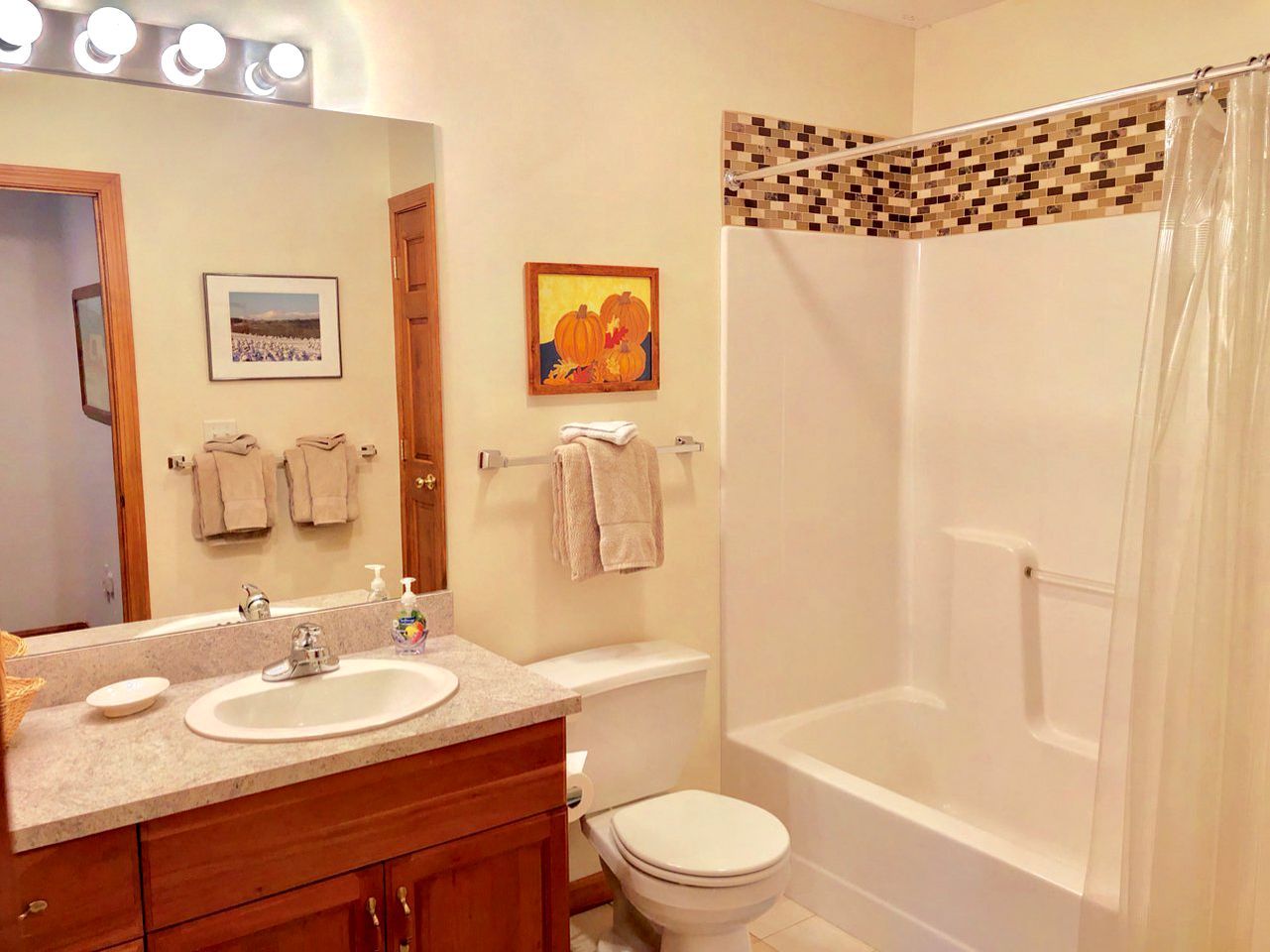 A bathroom with a sink, toilet, and bathtub.