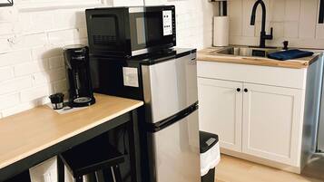 Fridge, microwave, coffee/tea maker, cookware/dishes/utensils