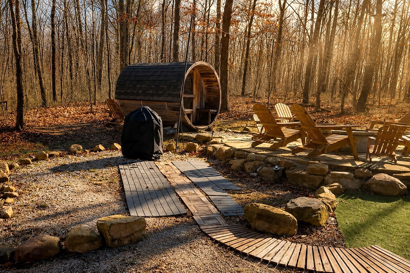 A rustic cabin with a wooden deck leading to a covered porch, surrounded by a forest.
