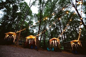 Three treehouses connected by a string of lights, each with a small porch and seating area. - Gypsy Cottage Near the Smokies, Sevierville, Tennessee (Sevierville)