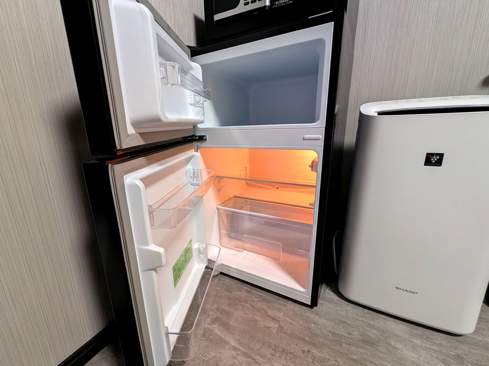 A kitchen with a double-door refrigerator and a side-by-side freezer.