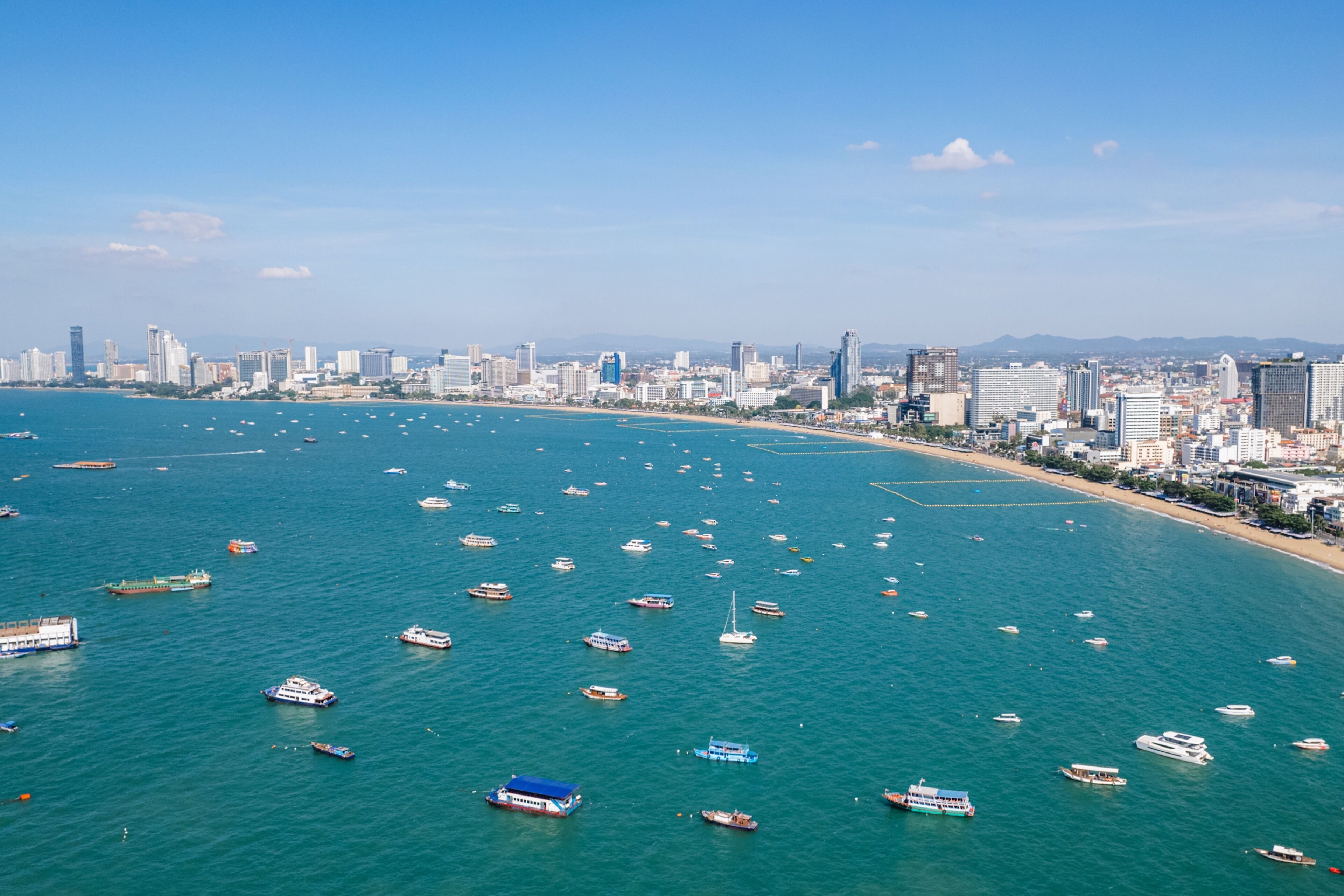 A coastal cityscape with a marina filled with boats.