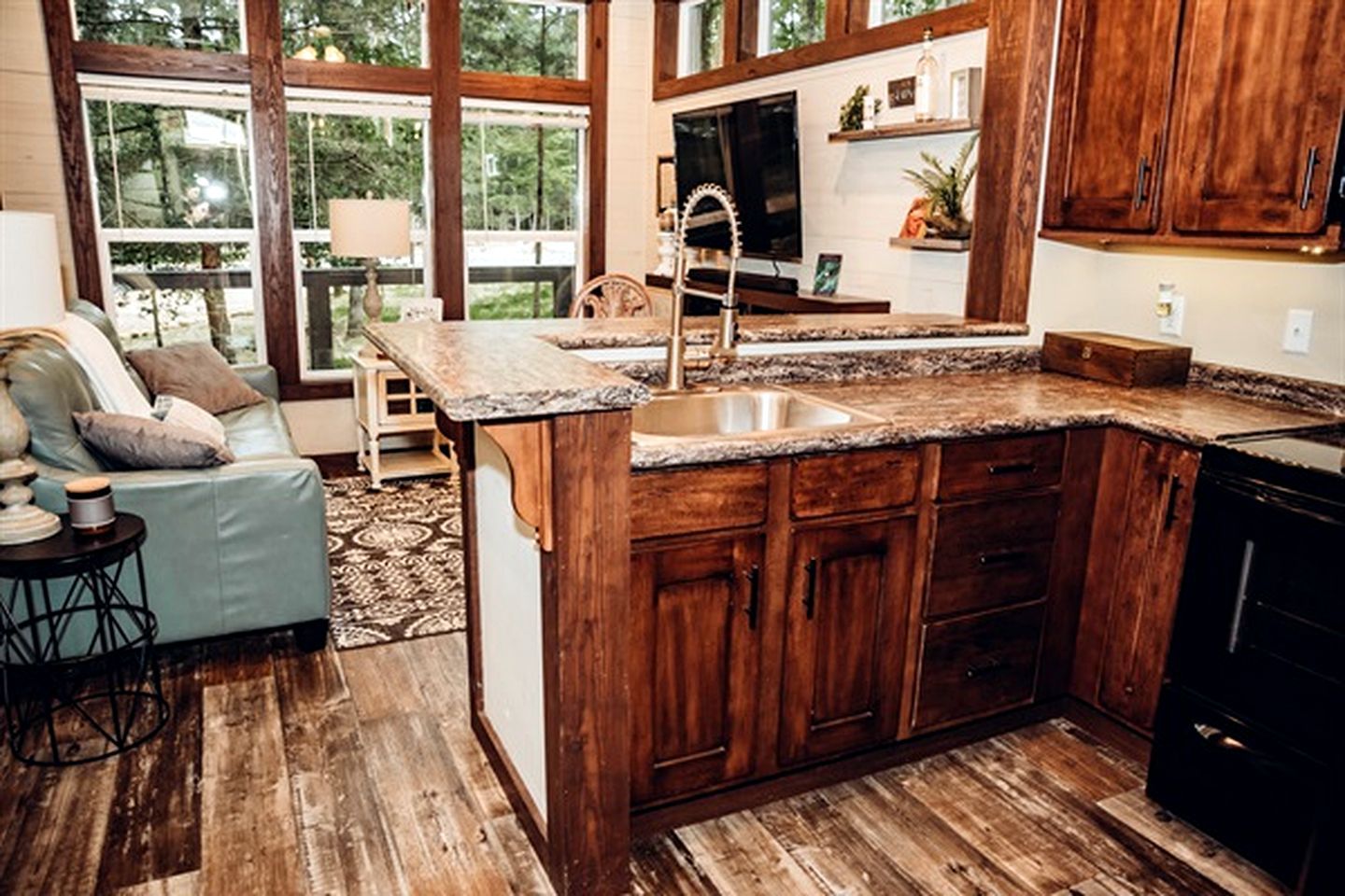 A kitchen with wooden cabinets, a granite countertop, and a sink.
