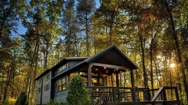 A cabin with a porch, surrounded by trees. - Incredible Secluded Cabin wit Barbecue and Privileged Sights in Tracy City, Tennessee (Tracy City)