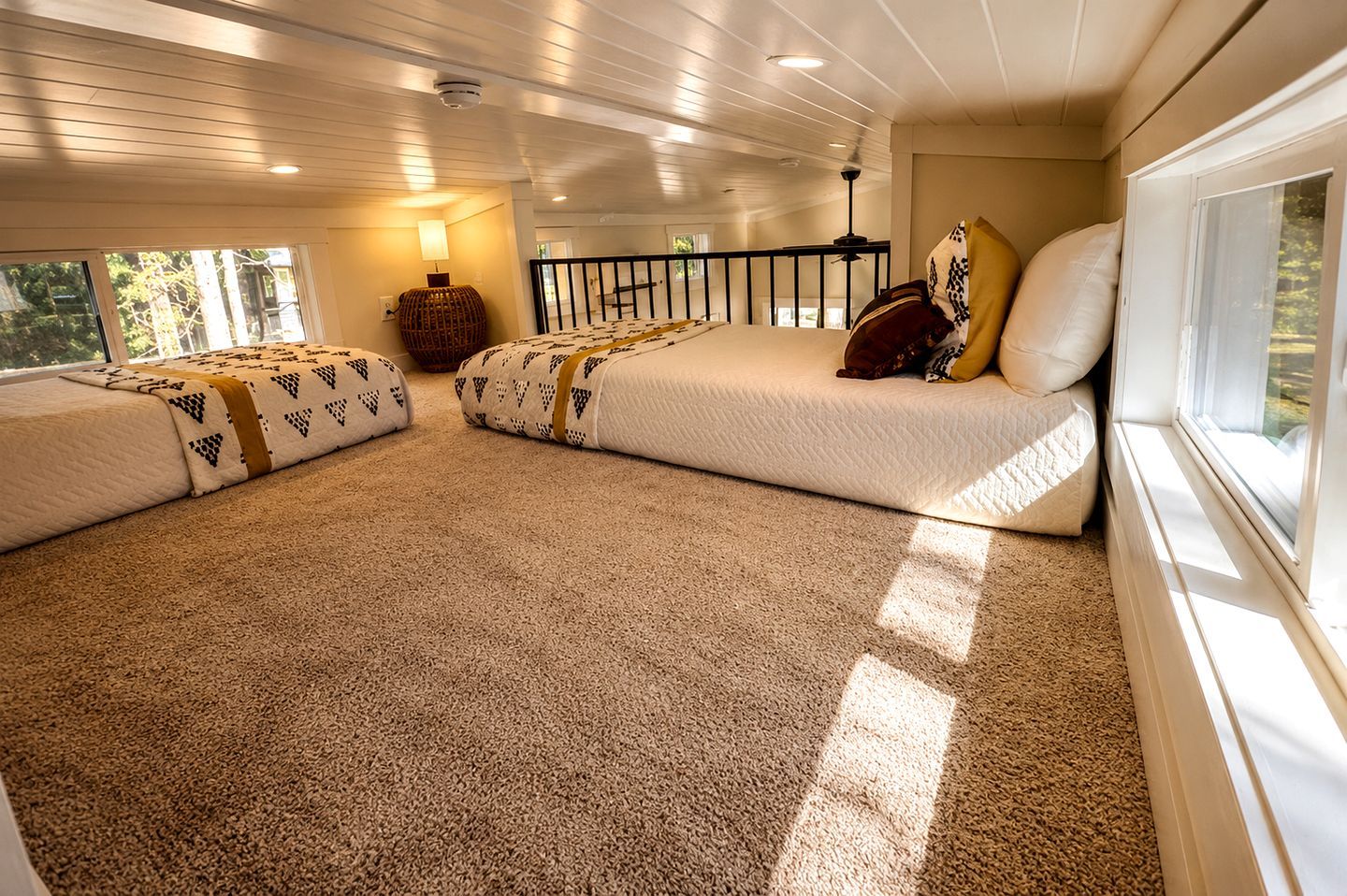 A room with a large bed, a window, and a ceiling fan.