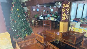 A traditional wooden interior with a Christmas tree, wooden furniture, and a brick wall. - Liberety Patong Resort (Patong)