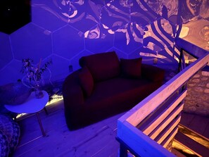 A modern living area with a sofa, a small table, and a decorative plant.