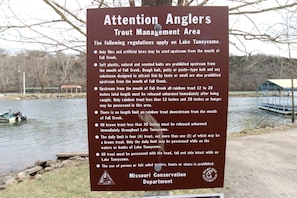 A sign detailing trout management regulations at Lake Taneycomo.