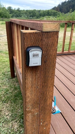 A wooden deck with a metal plaque on a post. - Blackcomb (Klamath)
