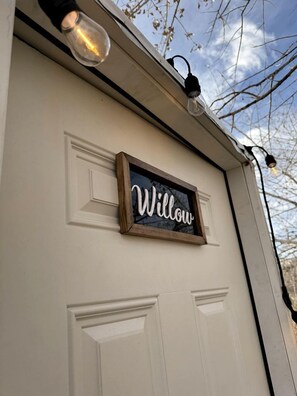 A white garage door with a 'Willow' sign and two light fixtures above it. - Amazing Dome with Stunning Sights in Wayne County, Utah (Torrey)