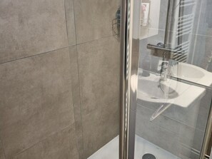 A glass-enclosed shower area with a white sink and a towel rack. - Studio Cabin F4 - 200m from Ski Slopes (Flaine)