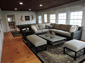 A living room with a pool table, a sofa set, and a coffee table. - Cabin Retreat for Nature and City Exploration near Sebago Lake State Park, ME (Casco)