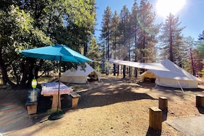 A campsite with tents, a picnic table, and a water dispenser. - Grand Adventures in Nature: Big Group-Friendly and Original Glamping in California (Mount Laguna)