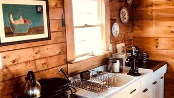 Stovetop, coffee/tea maker, cookware/dishes/utensils, dining tables