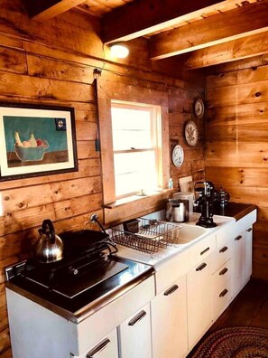 Stovetop, coffee/tea maker, cookware/dishes/utensils, dining tables - Naughty Dog Private Island Log Cabin in Monmouth, ME (Monmouth)