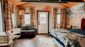 A room with a bed, a sofa, a dining table, and a chair. - Chic and Cozy: Romantic Glamping at Its Finest in Tennessee (Tracy City)