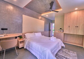 A modern bedroom with a bed, bedside table, chair, and wardrobe.