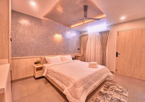 Un dormitorio moderno con cama, mesita de noche y ventilador de techo.